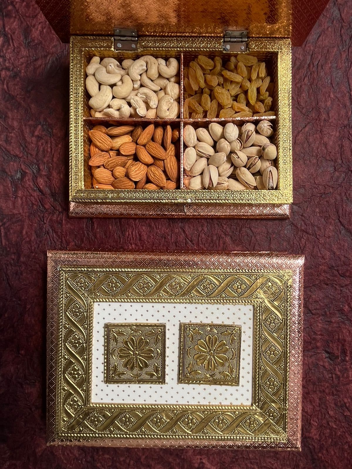 Four-compartment Rakhi dry fruit gift box with cashews, raisins, almonds and pistachios