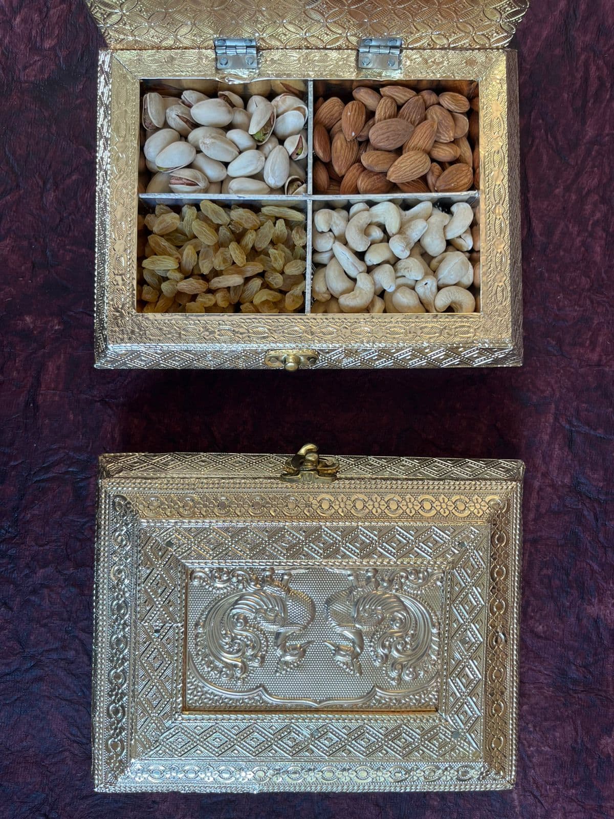 Silver decorative dry fruit box with almonds, pistachios, raisins and cashews