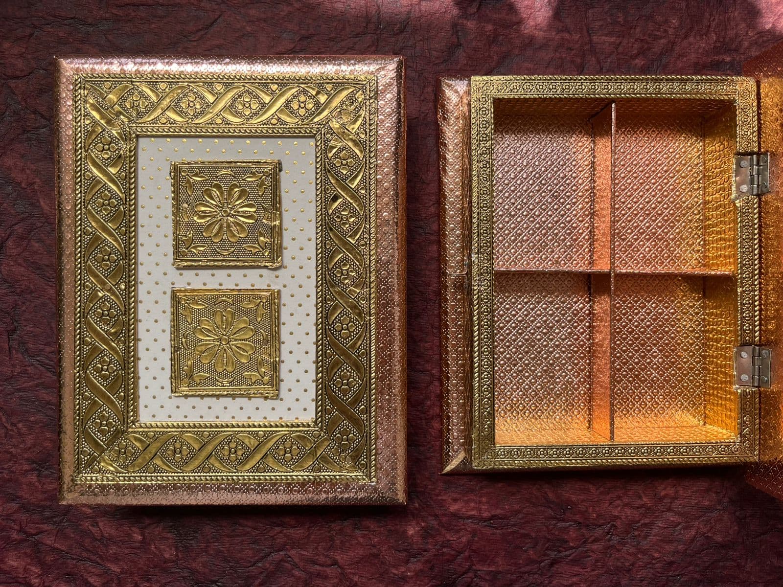 Open empty rose-gold Rakhi gift box with four compartments